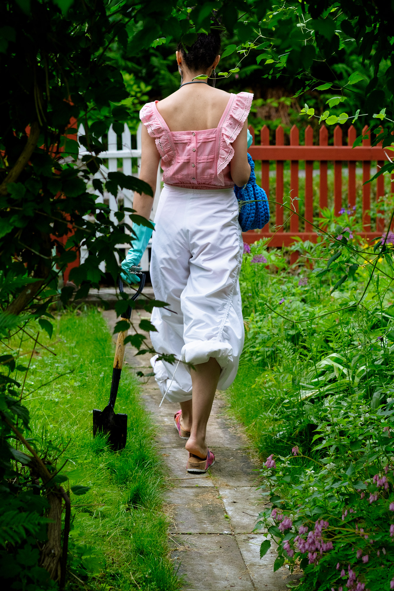 Krull magazine, Gardening Party fashion story. Model in lush green garden.