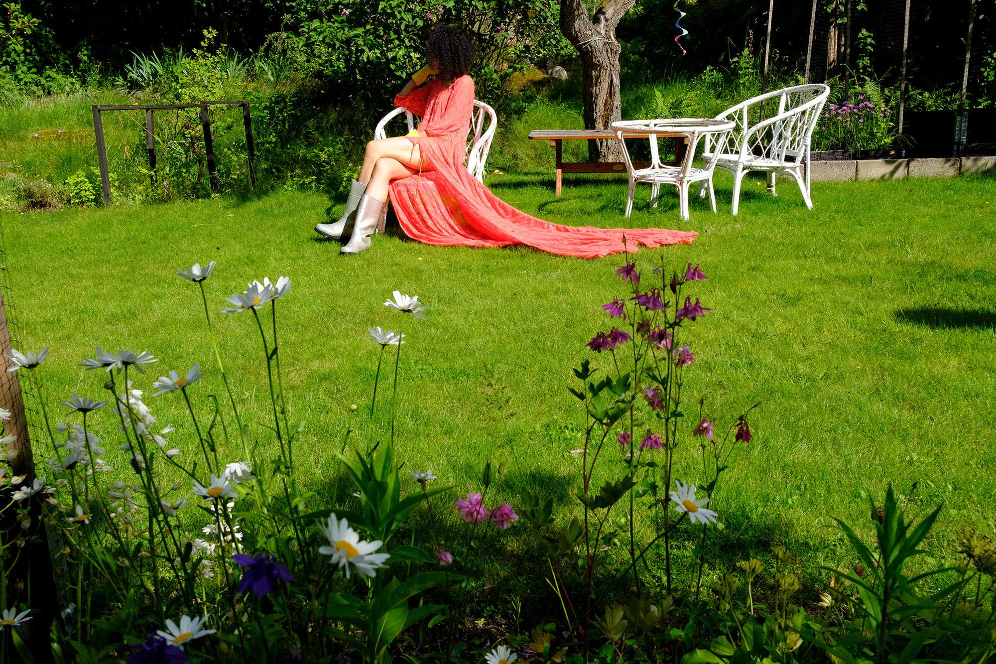 Gardening party, Krull magazine, model in Lisa Helena Jacobsson dress sitting on garden chair