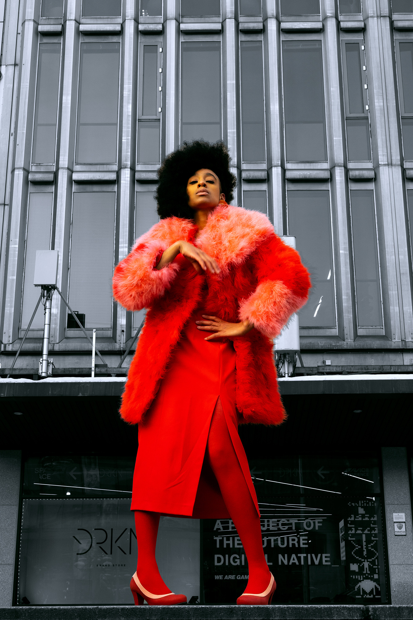 krullmag, shocking red fur coat against gray cityscape