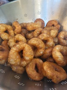 metal dish full of fresh beignets / sfenj