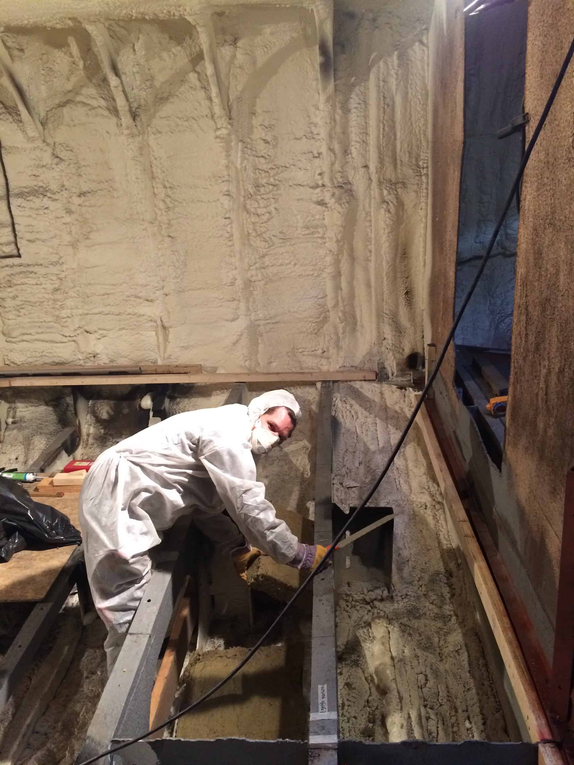 Mike is starting to put the insulation in the bottom of the boat