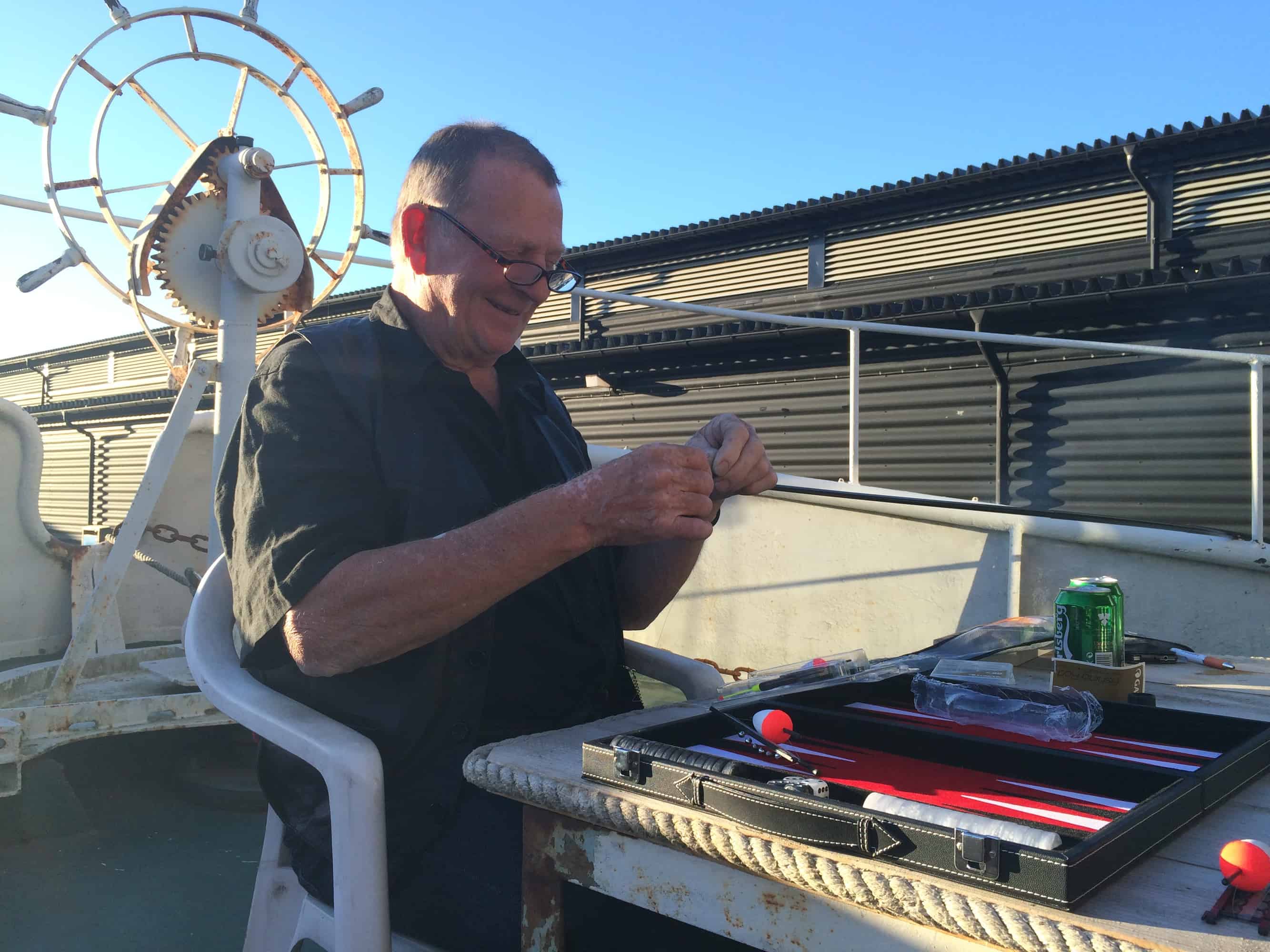 Björn is preparing the hook for the fishing rod