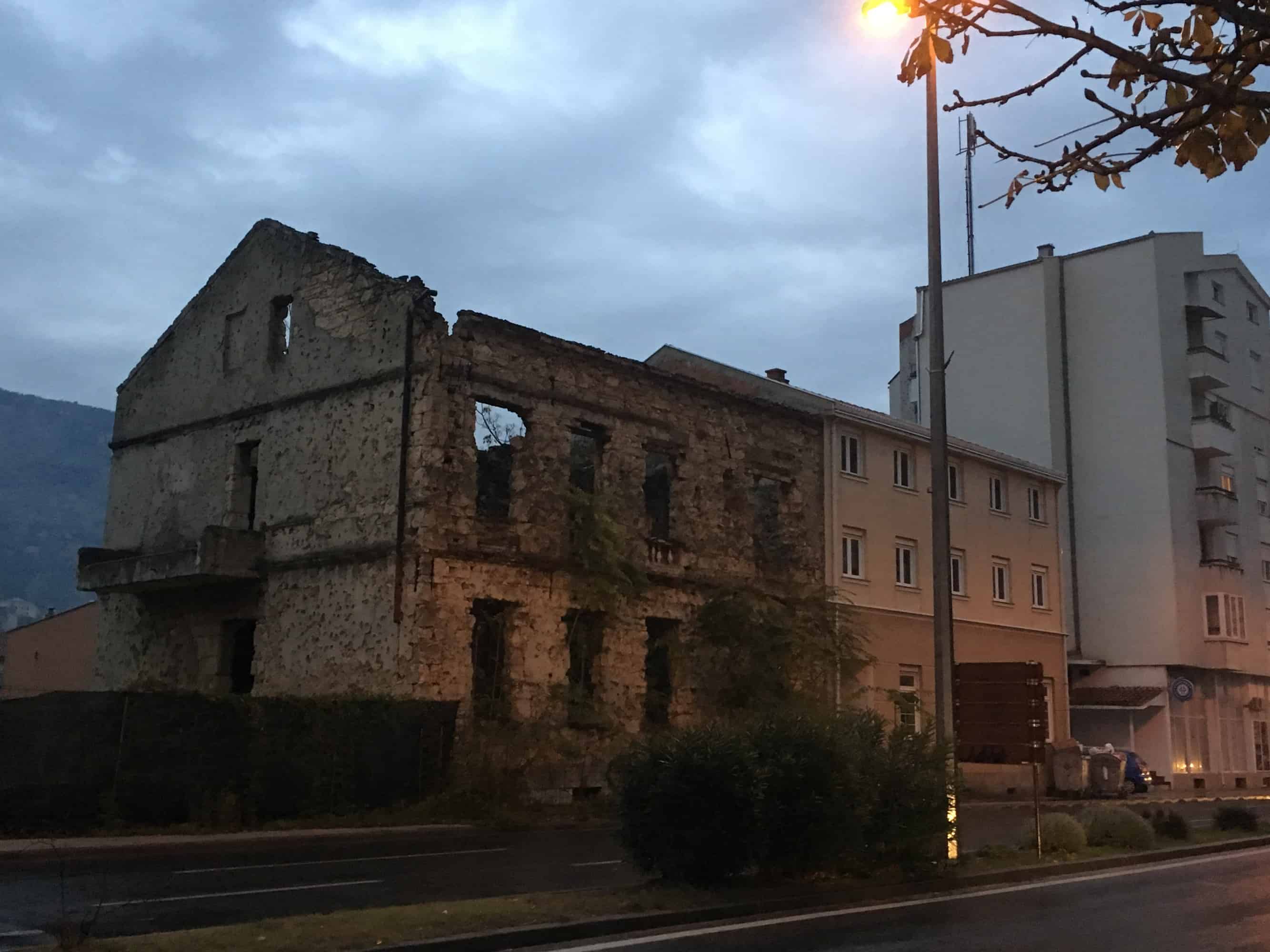 Destroyed building next to a renovated house