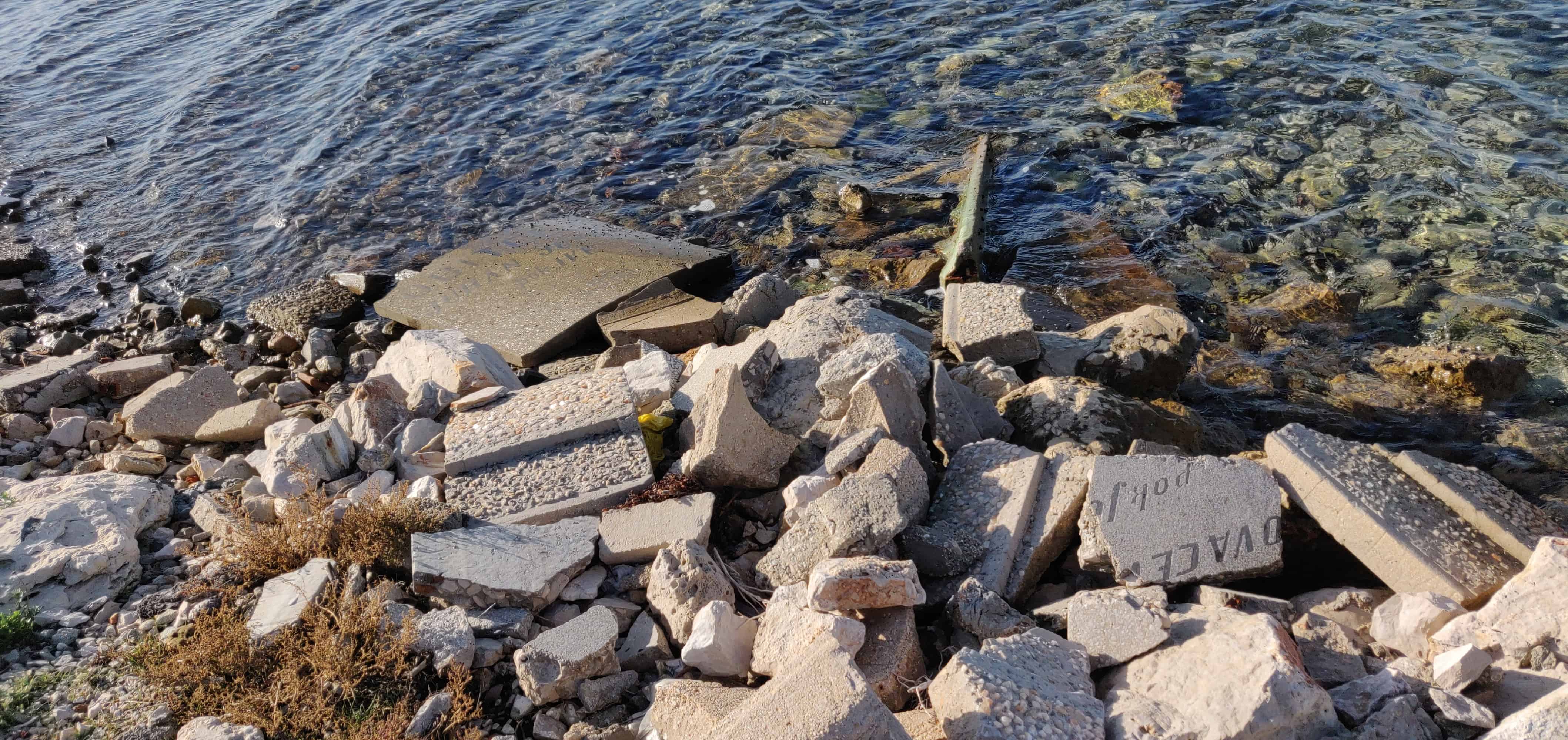 Old gravestones (from the church??)in the water