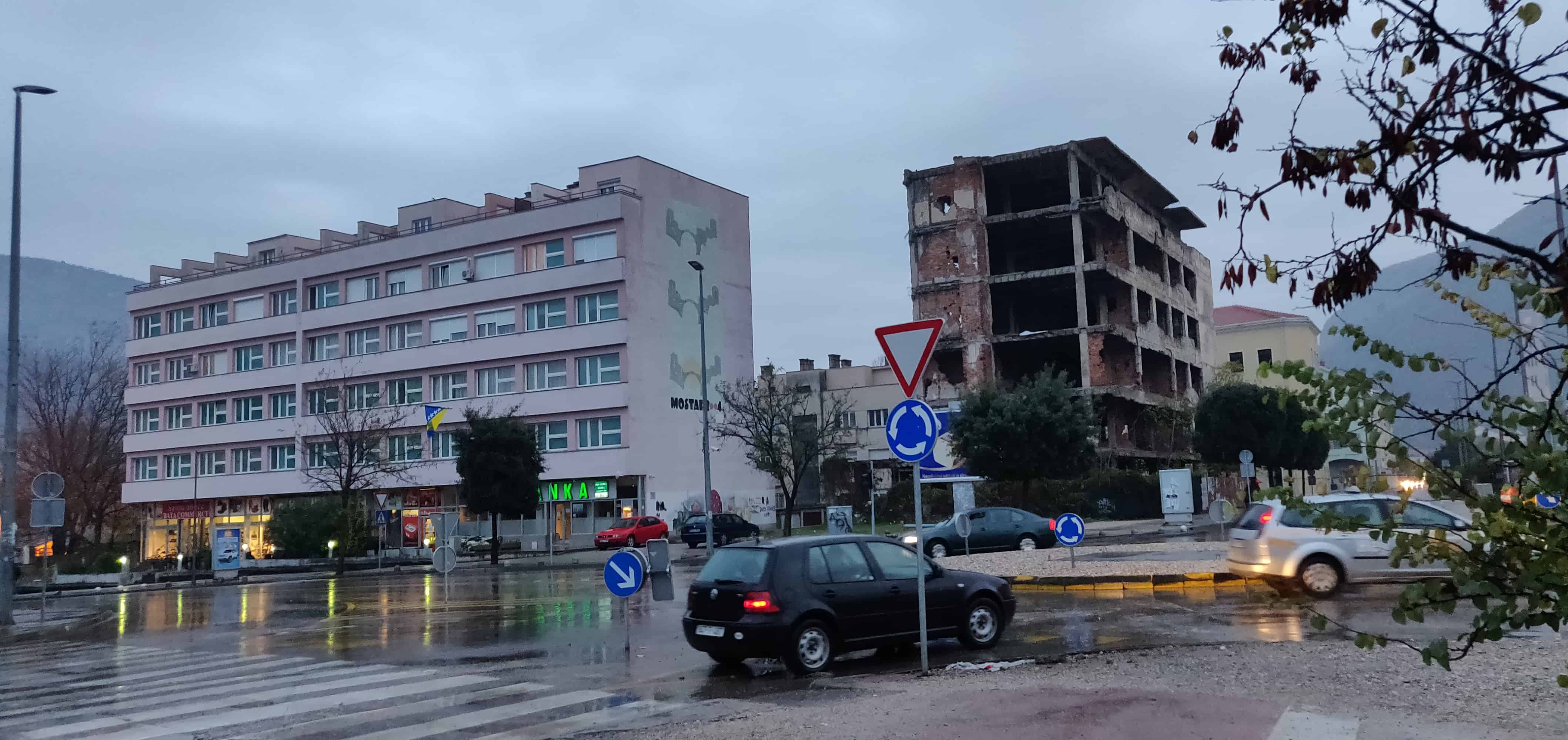 Destroyed building next to a renovated house