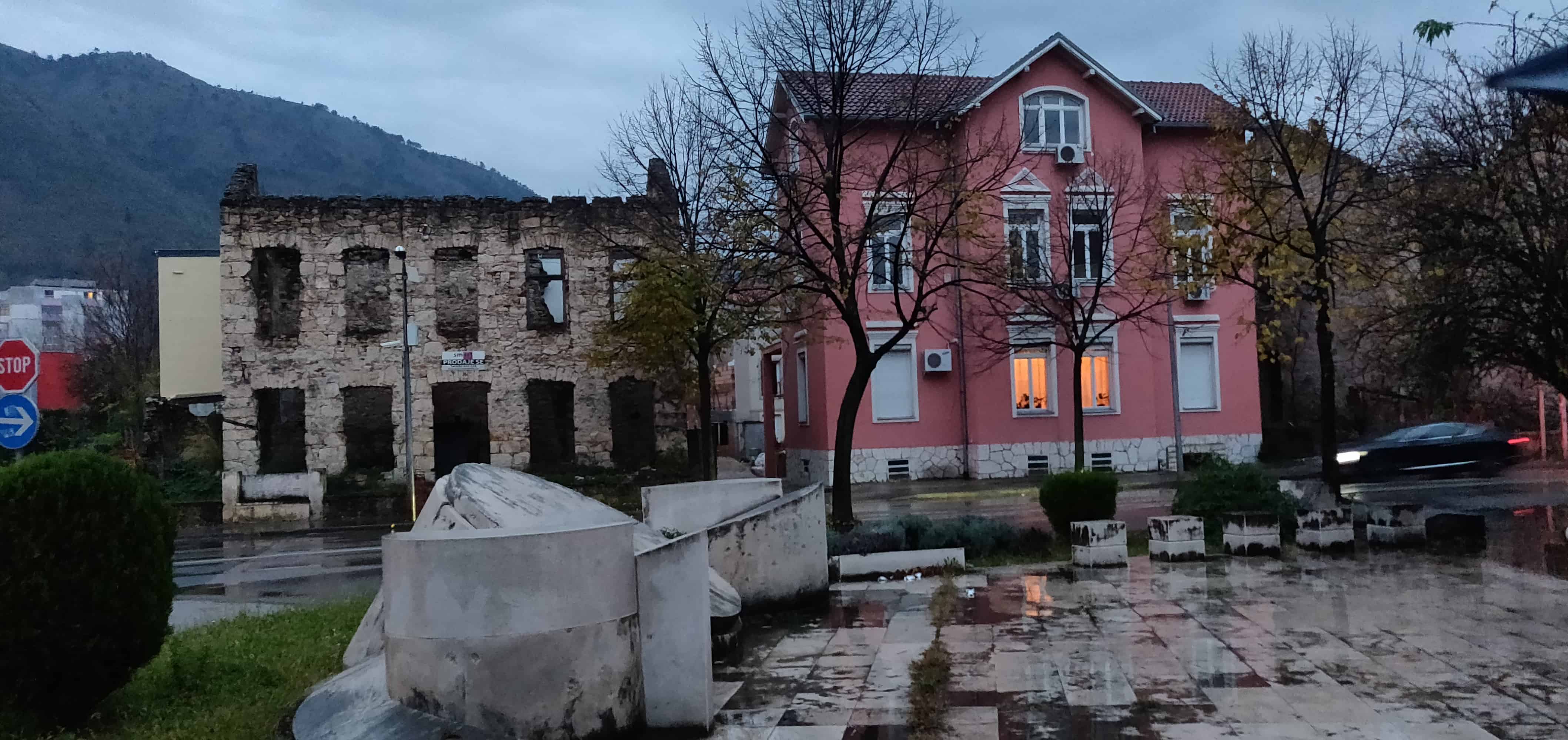 Destroyed building next to a renovated house