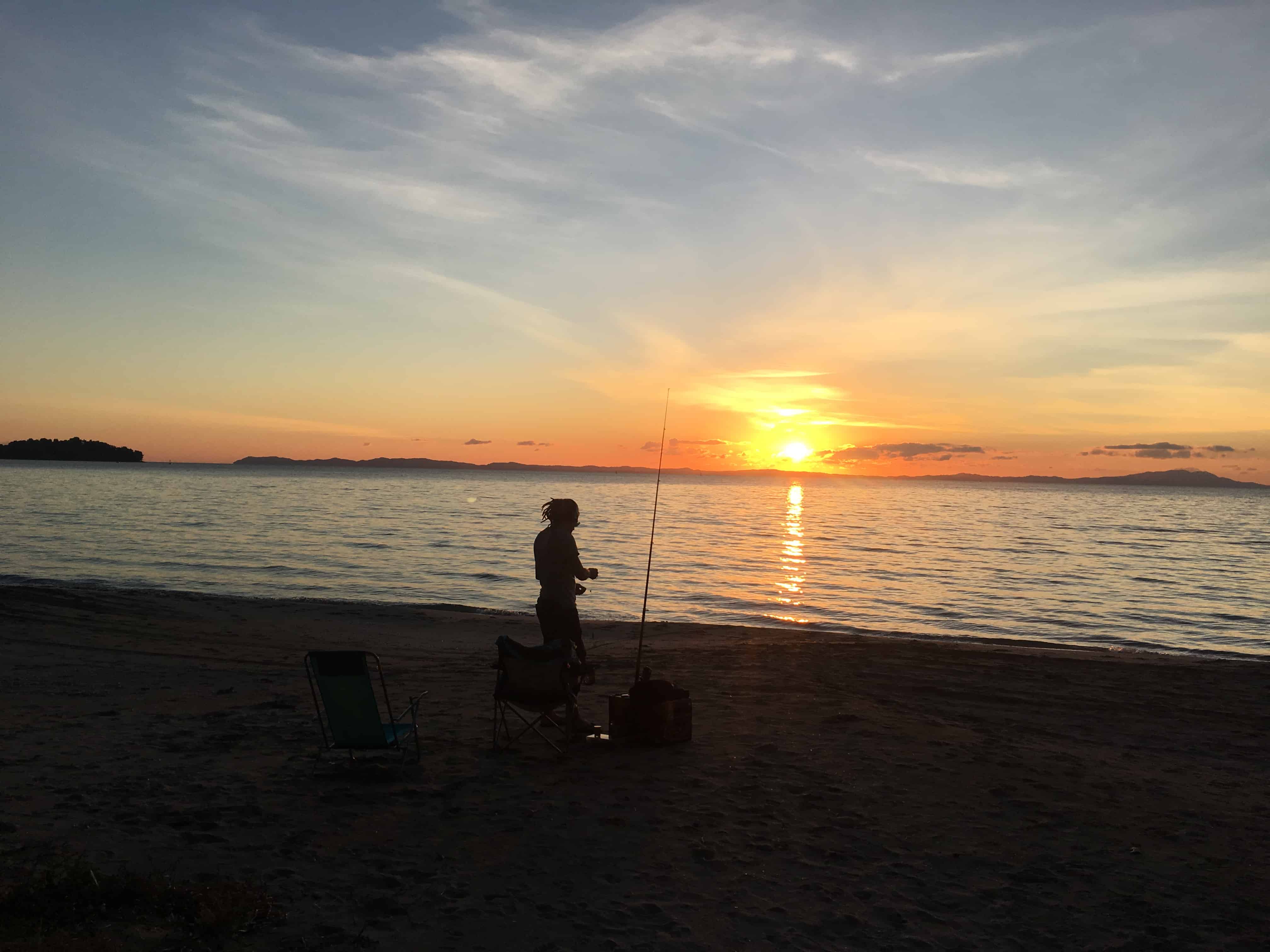 Mike is fishing in the sunset
