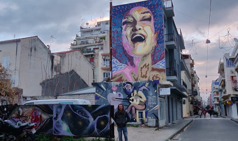 Mike in front of a grafitti wall in Patras