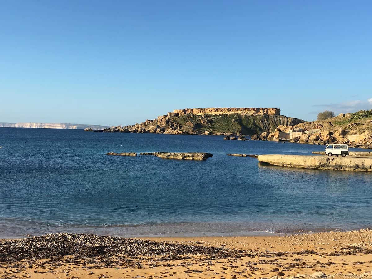 Gnejna bay, Gozo in the background on the left. Cute little car waiting for the sunset