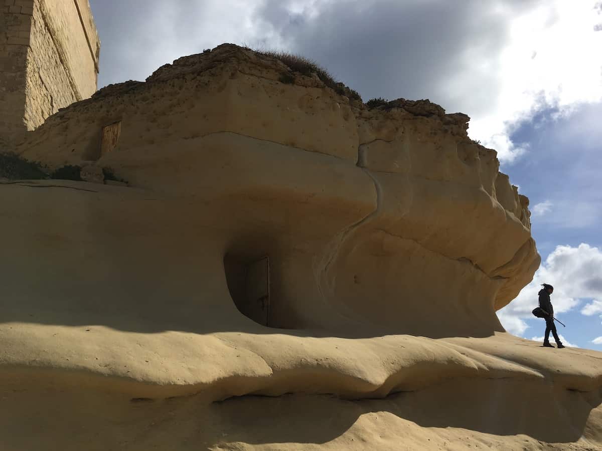 Mike on the cliff, you can see the door to the cave