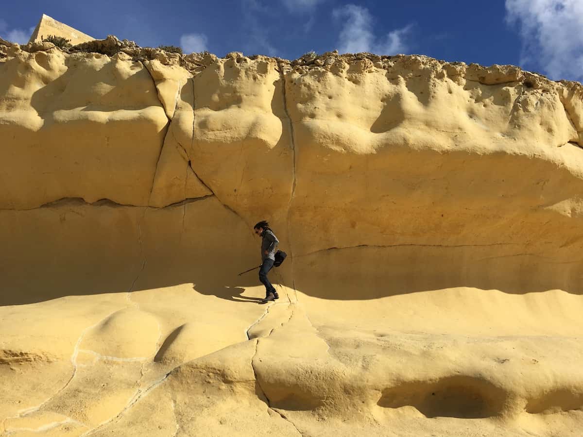 Mike walking on the limestone cliff