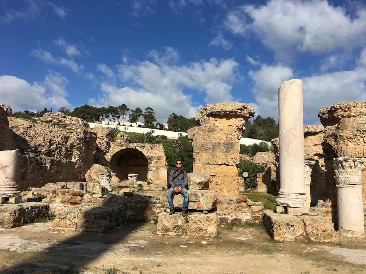 Mike is sitting by the ruins