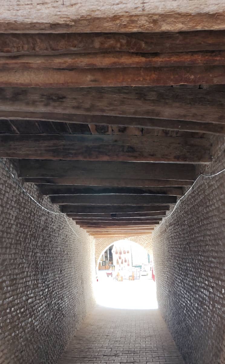 The shaded place under the bridge between two houses