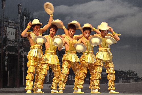 dance group exchanging hats