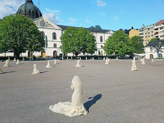 exhibition installation with toiles dresses