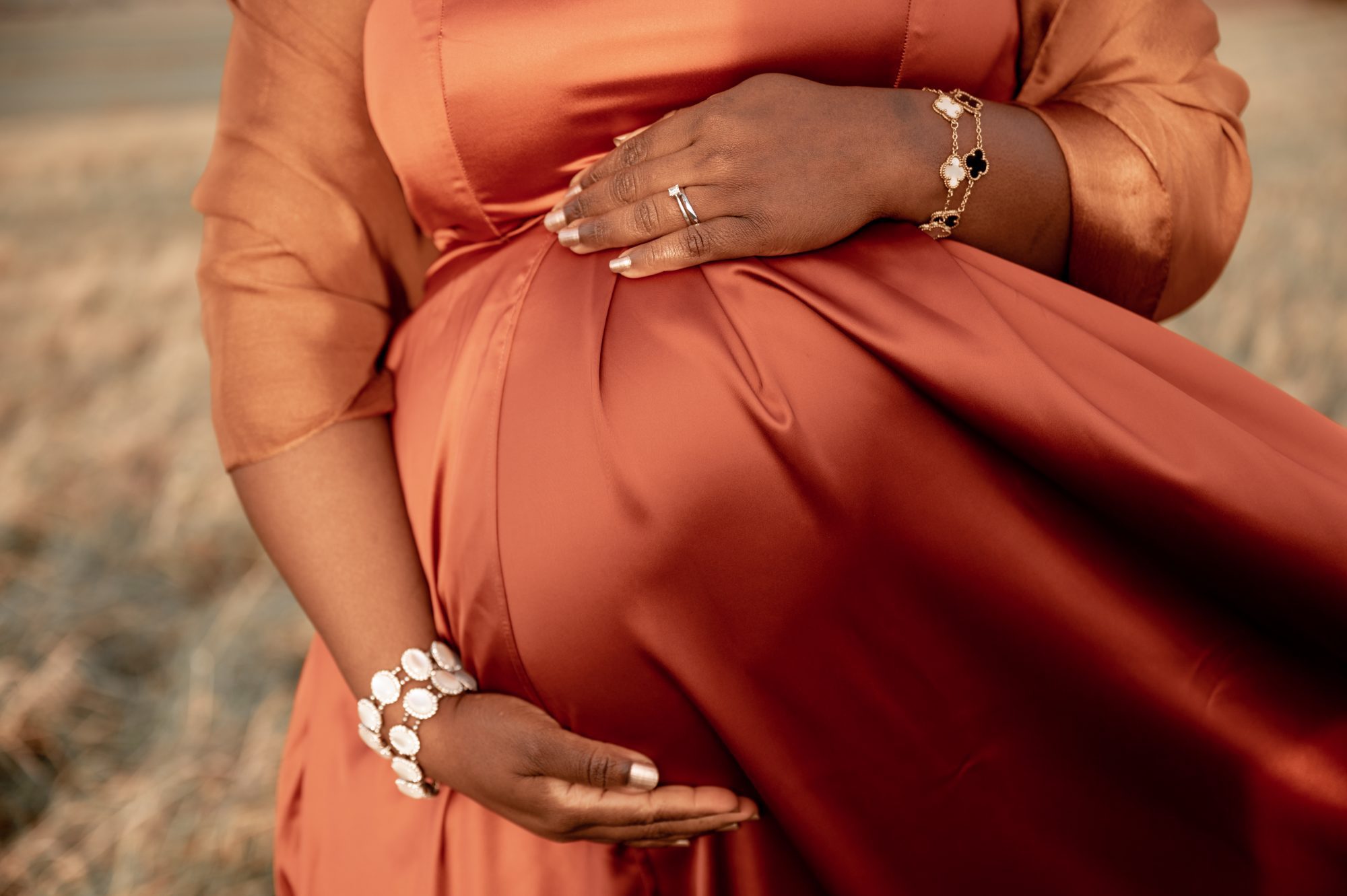 A pregnant woman holding her bump