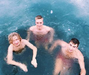 3 young lads ice bathing in Oslo fjord with smiles on their faces