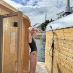 Norwegian girl taking a shower while at Mad Goats Sauna in Oslo. Sauna life on Oslofjord.