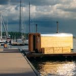 Two floating saunas in Tjuvholmen Oslo, with the Akershus fortress as a backdrop