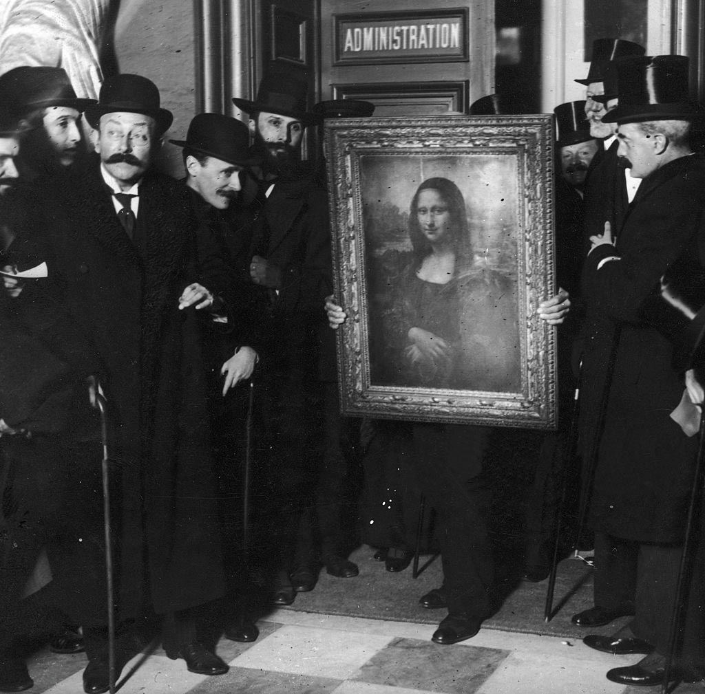 Officials gather around Leonardo da Vinci's 'Mona Lisa' upon its return to Paris, 1914. 