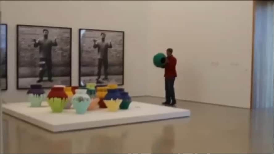 Artist Maximo Caminero at the Perez Art Gallery in Miami breaking one of the vases of Ai Weiwei's installationt, February 2014.