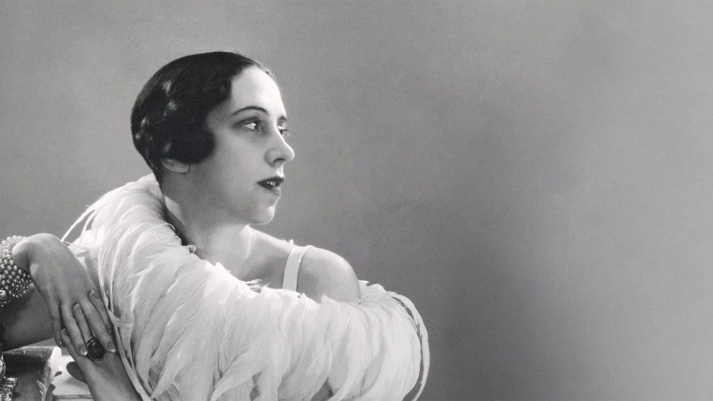 Elsa Schiaparelli wearing a feather boa (1932)