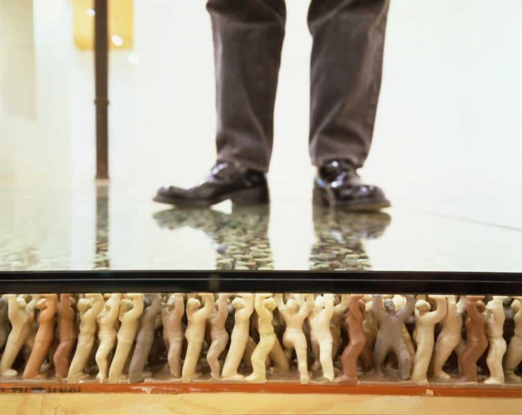 Do Ho Suh - Floor. Humanlike PVC figures supporting a glass floor.