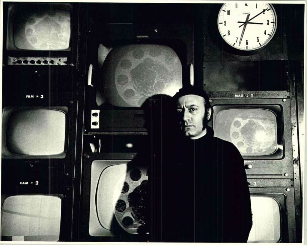 Aldo Tambellini in front of televisions. Courtesy of The Aldo Tambellini Art Foundation.