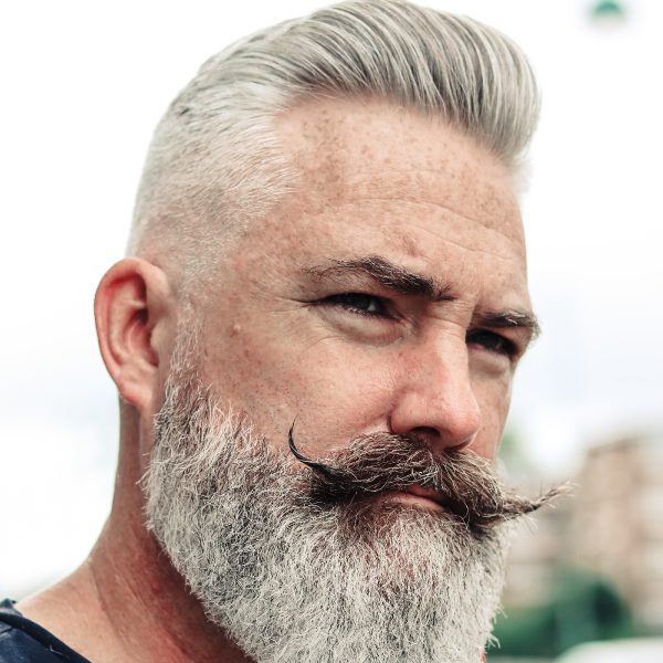 Pompadour Hairstyle With Full Beard and Curly Handlebar Moustache