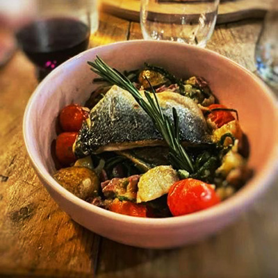 Poached seabass on a bed of ciabatta and cherry tomatoes