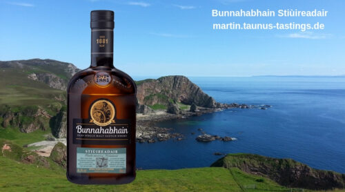 Eine Flasche Bunnahabhain Stiùireadair, im Hintergrund die Küste auf Islay