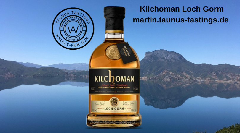 Eine Flasche Kilchoman Loch Gorm, in Hintergrund ein See in Schottland