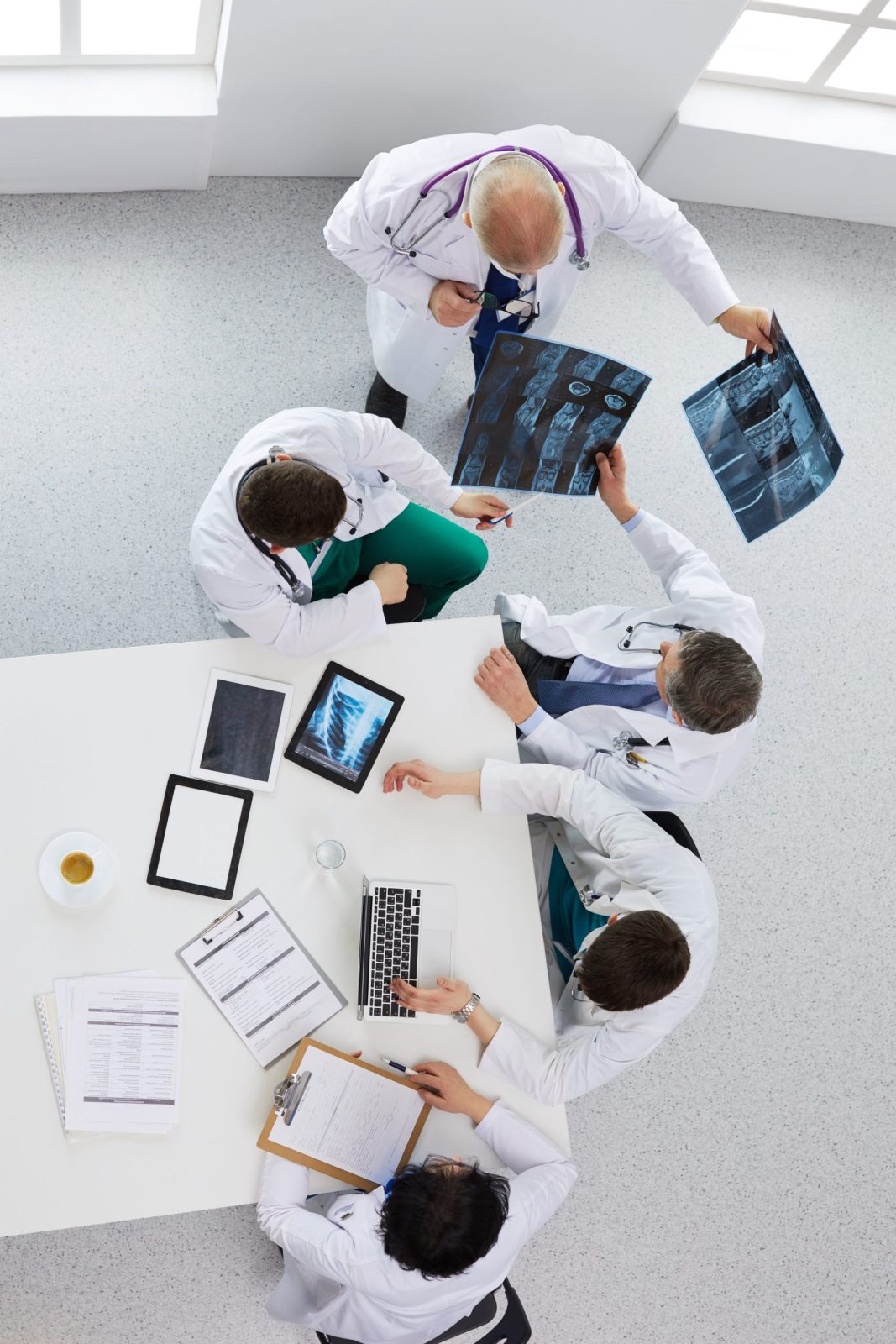 Medical team sitting and discussing at table, top view