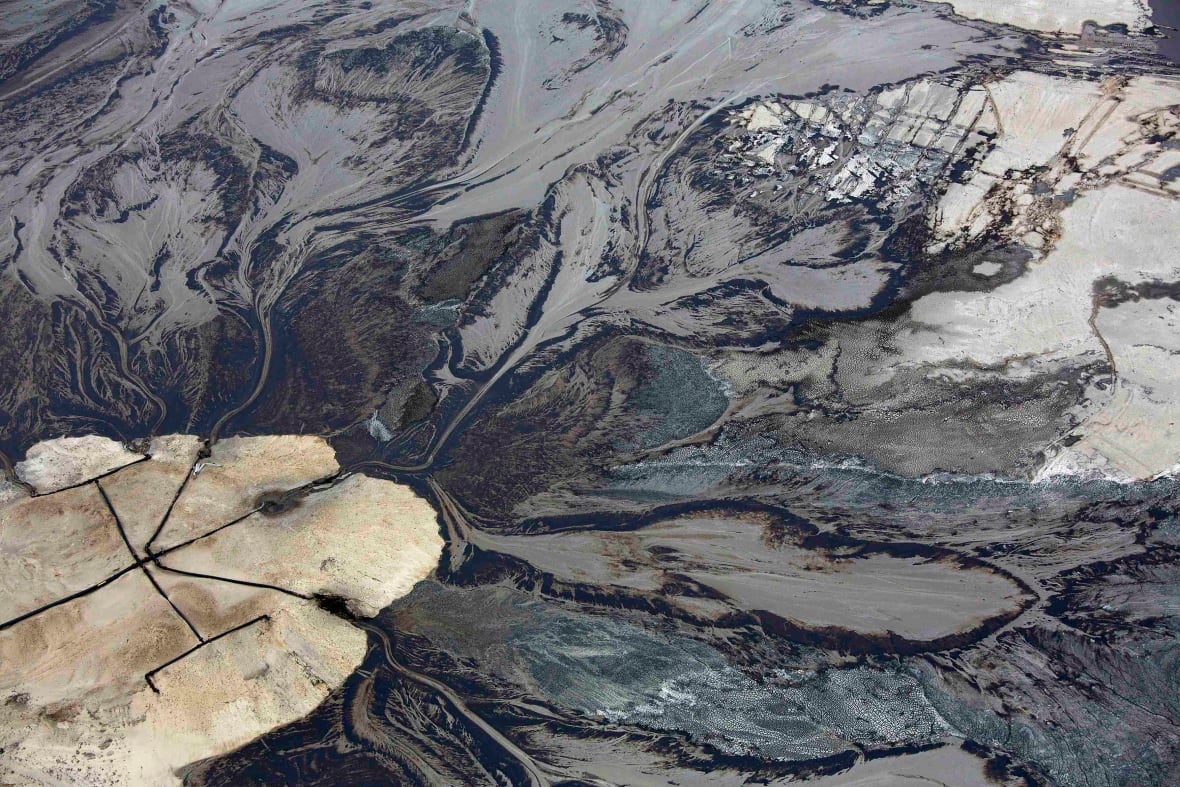 Oil goes into a tailings pond at the Suncor oilsands operations near Fort McMurray, Alta.