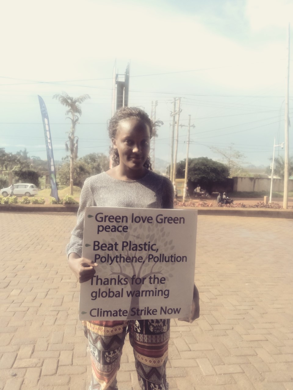 Ugandan climate activist protests on the street in Kampala.