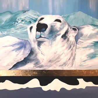 Isbjørn der kigger frem fra klipperne