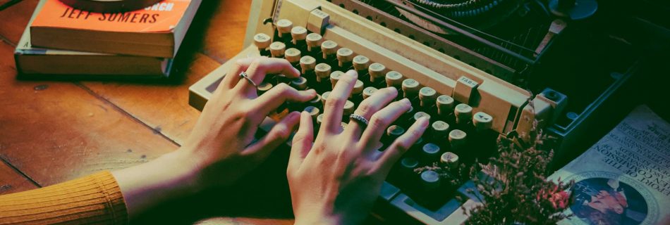 person using typewriter