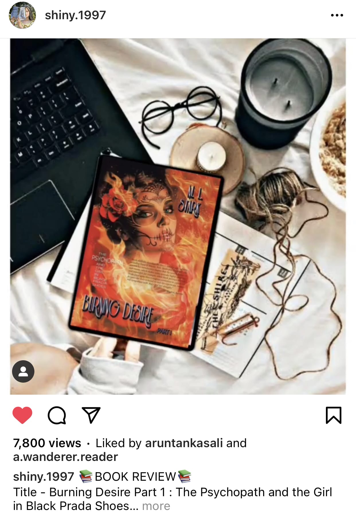 Instagram-style reader review featuring the original 2021 edition Burning Desire Part I: The Psychopath and the Girl in Black Prada Shoes by M. L. Stark displayed on a reading desk with coffee, candlelight, handwritten notes, and reading glasses.