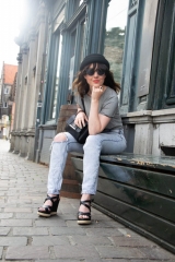 The Alchemist Model sitting outside with sunglasses