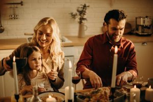 Deck the Halls (and the Kitchen)! A Real-Life Mallorcan Holiday Tale 15 Family enjoying a cozy holiday dinner together, sharing love and joy indoors.