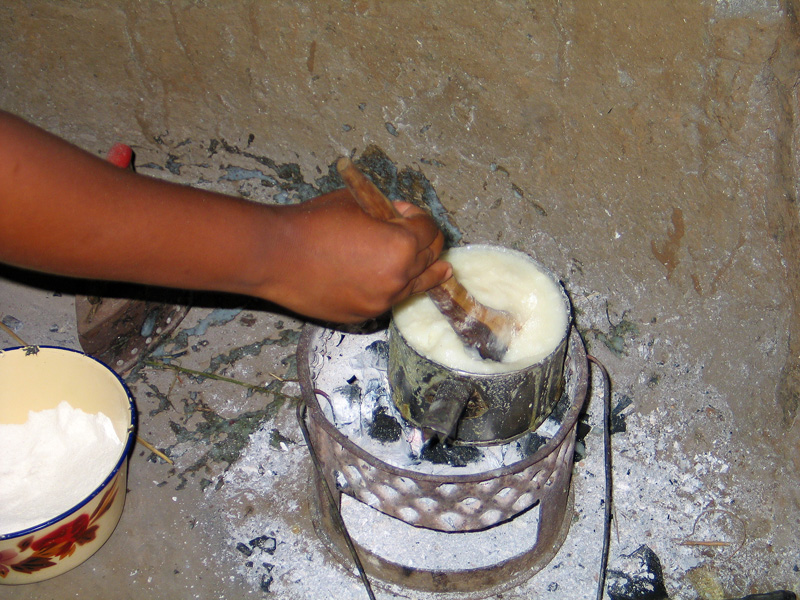 Cooking Nshima over charcoal fire