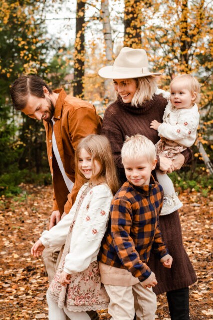 Familj busar på en familjefotografering utomhus i Stockholm