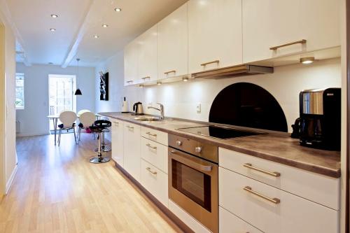 Full kitchen with dining area in background