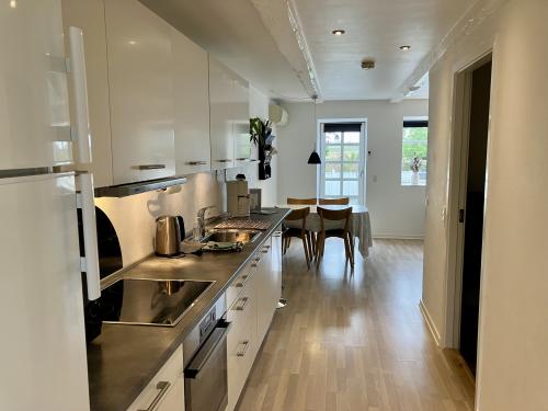 Full kitchen with dining area (and door to terrace in background)