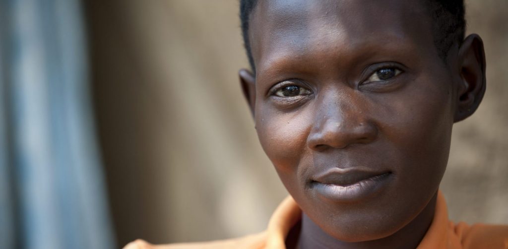 A portrait of a woman looking in the camera with a slight smile.