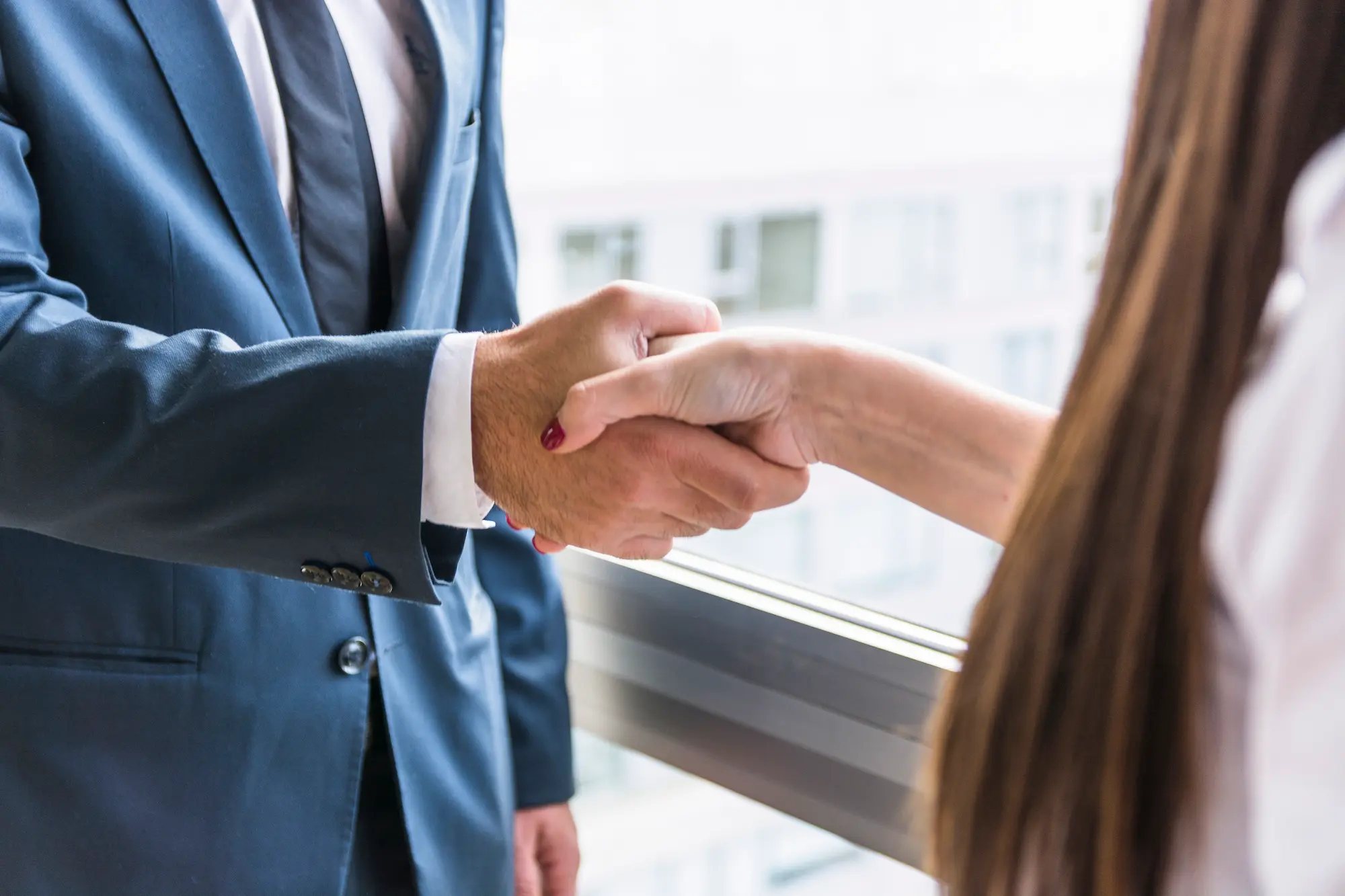 close-up-businesswoman-businessman-shaking-hands