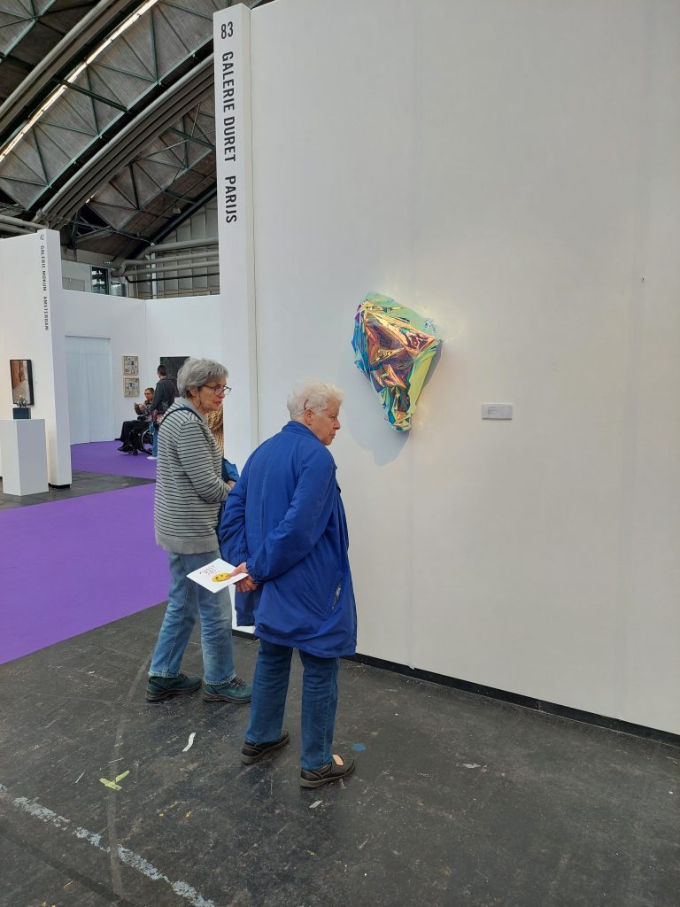 Art Viewers Investigating the Works of Johannes Holt Iversen at the Booth of Galerie Duret Paris
