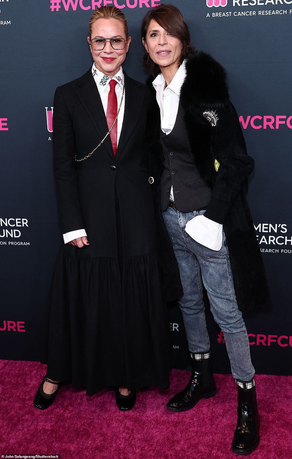 Unforgettable: Maria Bello was a sight to see in a suit-skirt combo and cross-body chain as she posed up a storm beside her girlfriend Dominique Crenn of Iron Chef fame