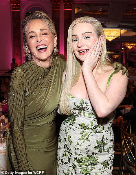 Loving life: Sharon was in high demand on the evening as she was pulled for pictures with Kim a