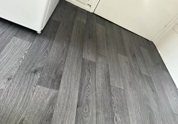 The savvy TikTok user turned her floor from blue to a chic grey wood look